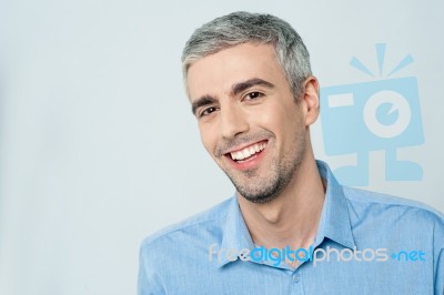 Smiling Young Man Posing To The Camera Stock Photo