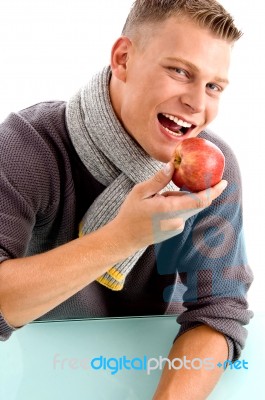 Smiling Young Man Posing With Apple Stock Photo