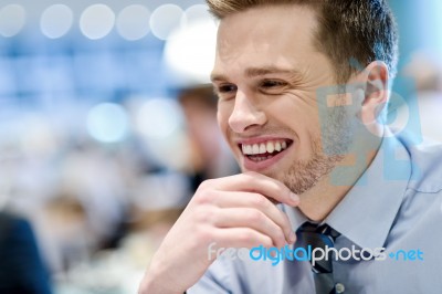 Smiling Young Man Sitting In A Outdoor Cafe Stock Photo