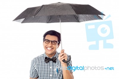 Smiling Young Man With An Umbrella Stock Photo