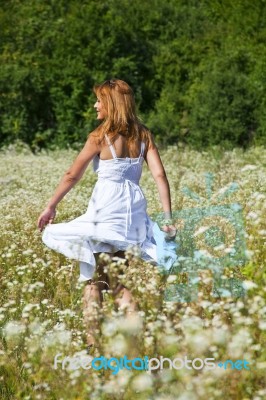 smiling young Woman In Meadow Stock Photo