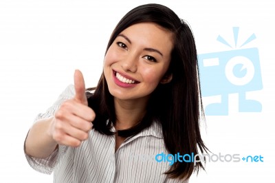 Smiling Young Woman Showing Thumbs Up Stock Photo