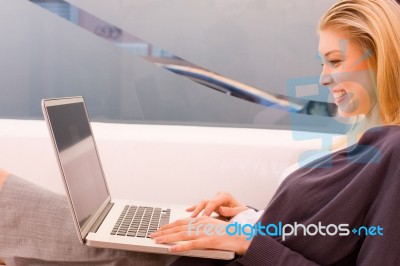 Smiling Young Woman Using Laptop Stock Photo