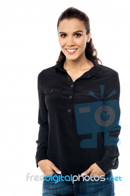 Smiling Young Woman With Hand In Pocket Stock Photo