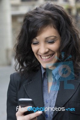 Sms And Smile Of Young Woman Stock Photo