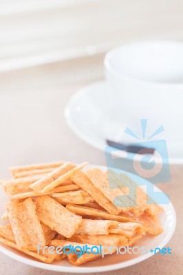 Snack On White Plate With Coffee Cup Stock Photo