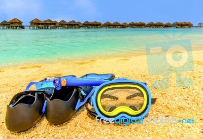 Snorkling Gear On The Beach With Water Bungalows And The Beach In Maldives Stock Photo