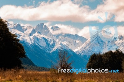 Snow Caped Mountain Scape With A Flat Plain Stock Photo