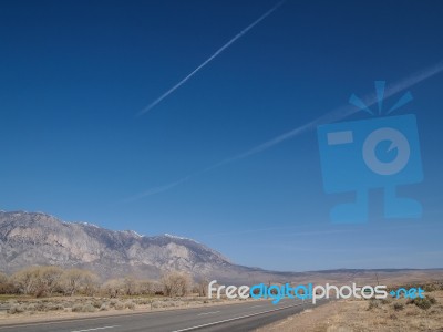 Snow Capped Mountains, Blue Sky, Desert Landscape Stock Photo