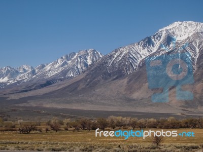 Snow Capped Mountains, Blue Sky, Desert Landscape Stock Photo