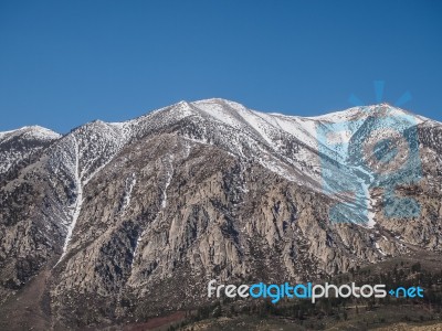 Snow Capped Mountains, Blue Sky, Desert Landscape Stock Photo