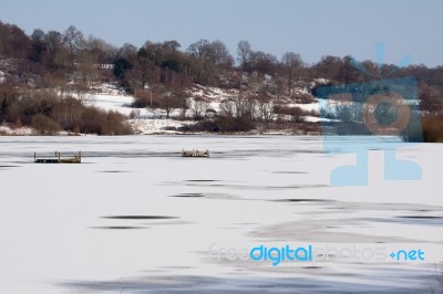 Snow Laying On The Ice At Weir Wood Reservoir Stock Photo