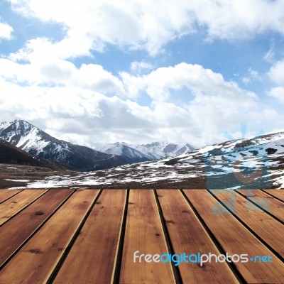 Snow Mountain With Sky And Wood Floor Stock Photo