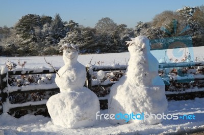 Snowman And Woman Stock Photo