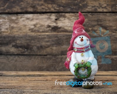 Snowman Standing On Old Wooden Table Stock Photo