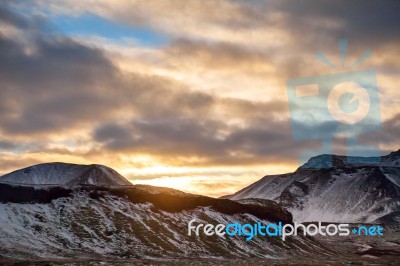 Snowy Icelandic Mountains With Dramatic Cloudy Sky Stock Photo