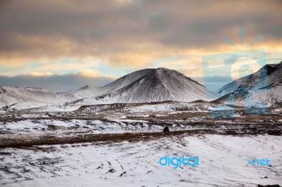 Snowy Icelandic Mountains With Dramatic Cloudy Sky Stock Photo