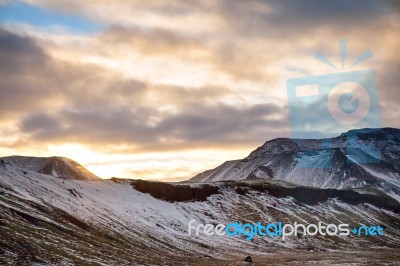 Snowy Icelandic Mountains With Dramatic Cloudy Sky Stock Photo