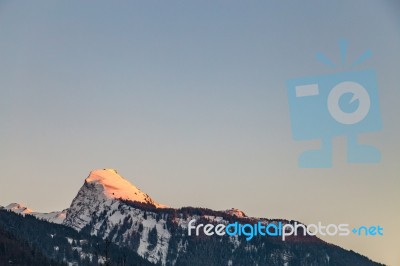 Snowy Mountain Tops In The Blue Sky Sun Stock Photo