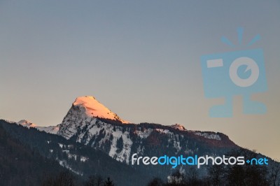 Snowy Mountain Tops In The Blue Sky Sun Stock Photo