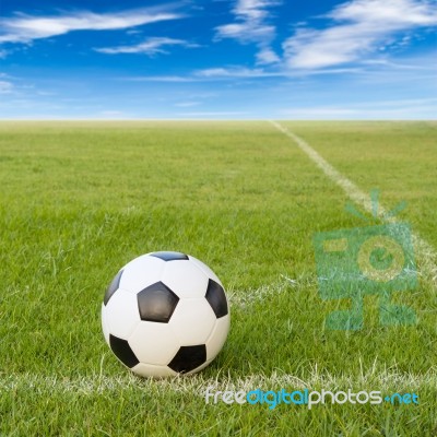 Soccer Ball On Soccer Field Against Blue Sky Stock Photo