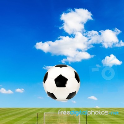 Soccer Ball With Soccer Field Against  Blue Sky Background Stock Photo