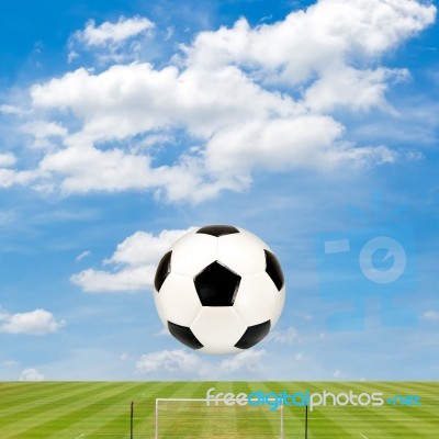 Soccer Ball With Soccer Field Against  Blue Sky Background Stock Photo