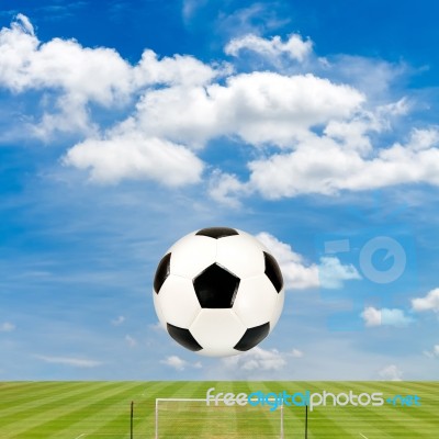 Soccer Ball With Soccer Field Against  Blue Sky Background Stock Photo