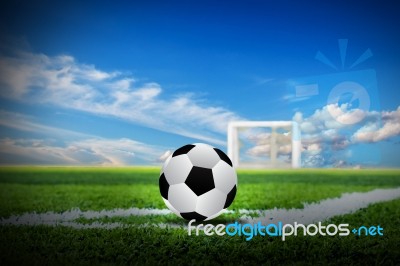 Soccer On Green Field With Sky Background Stock Photo