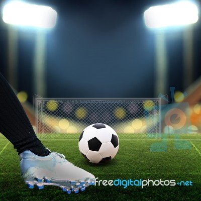 Soccer Player Kicking Soccer Ball Stock Photo