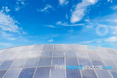 Solar Panels Against Blue Sky Background Stock Photo