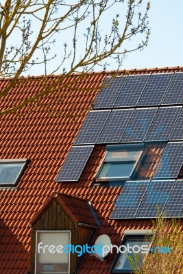 Solar Panels On A Red Roof Stock Photo