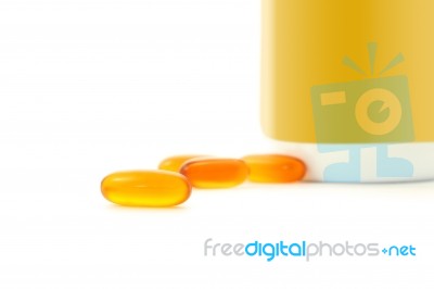 Some Oil Pills And Bottle On White Background Stock Photo