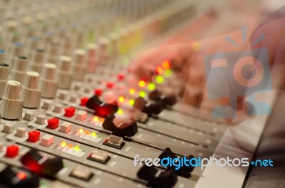 Sound Engineer's Hand Moving On Sound Mixing Board Stock Photo