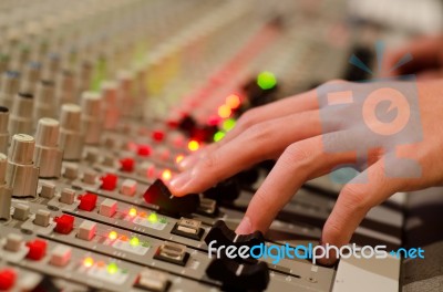 Sound Engineer's Hand Moving On Sound Mixing Board Stock Photo