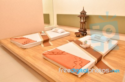 Spa Room With Interior Consisting Of Bed, Pillows And Towels Stock Photo