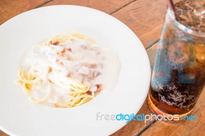 Spaghetti Carbonara With Ham Cheese And Cola Stock Photo