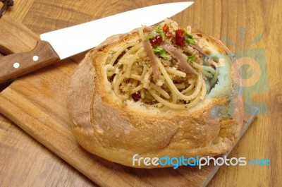 spaghetti In Bread with knife Stock Photo