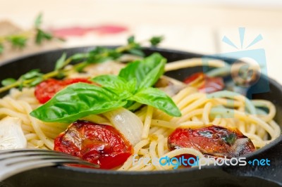 Spaghetti Pasta With Baked Cherry Tomatoes And Basil Stock Photo