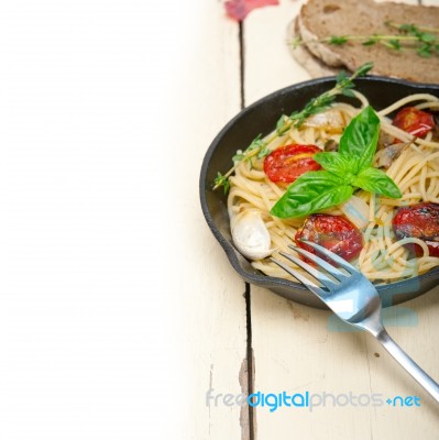 Spaghetti Pasta With Baked Cherry Tomatoes And Basil Stock Photo