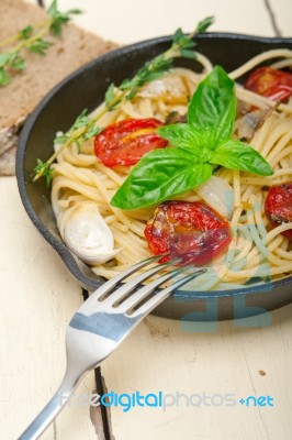 Spaghetti Pasta With Baked Cherry Tomatoes And Basil Stock Photo