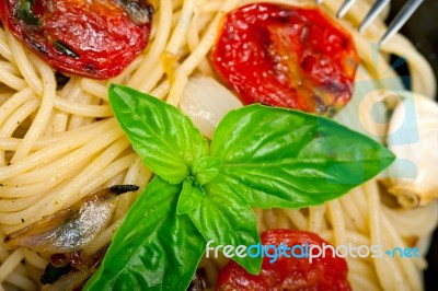 Spaghetti Pasta With Baked Cherry Tomatoes And Basil Stock Photo