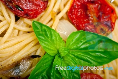 Spaghetti Pasta With Baked Cherry Tomatoes And Basil Stock Photo