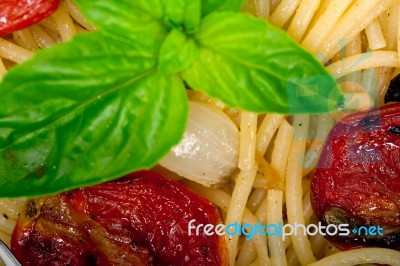 Spaghetti Pasta With Baked Cherry Tomatoes And Basil Stock Photo