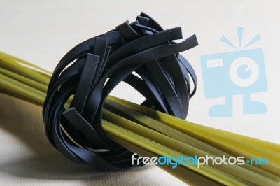 Spanich And Squid Ink Black Pasta On Wood Background Stock Photo