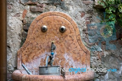 Sparrow Drinking From A Tap In Verona Stock Photo