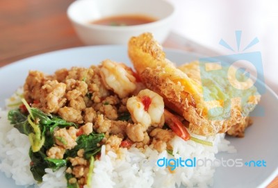 Spicy Fried Pork And Shrimp With Basil Leaves And Fried Egg Stock Photo