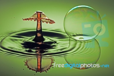 Splash And Bubble With Reflections Stock Photo