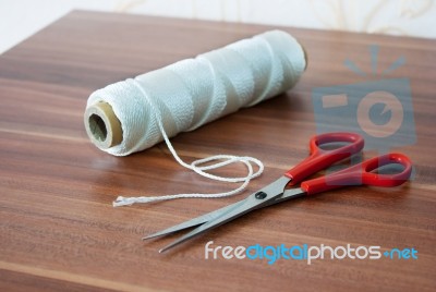 Spool Of Thread With Scissors Stock Photo