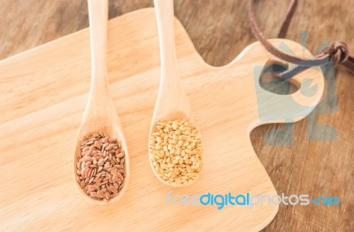 Spoon Of Flax Seed On Wooden Table Stock Photo
